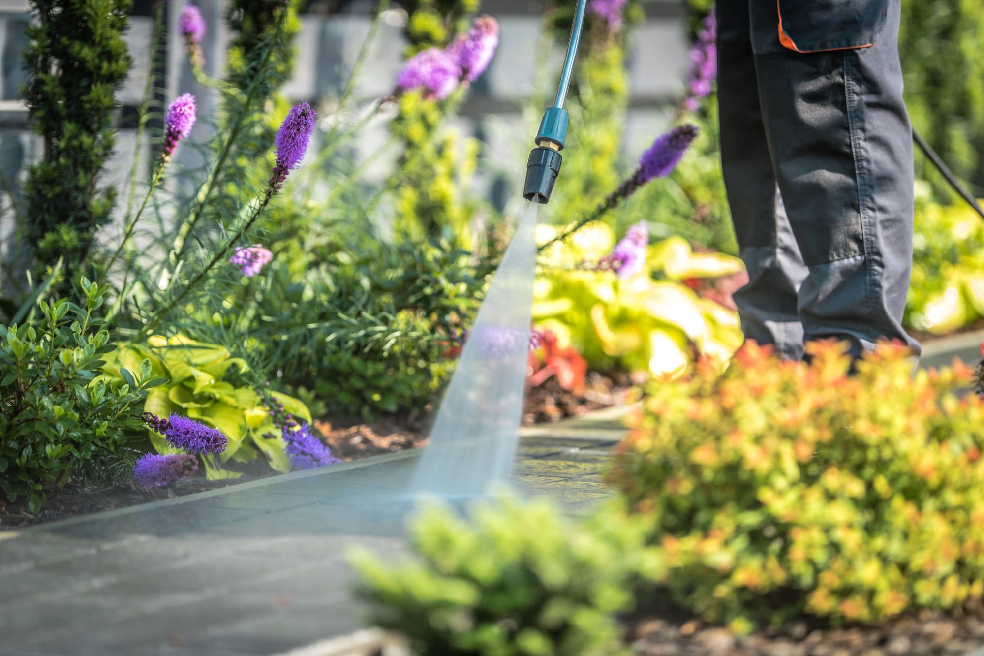 dreamstime_m_122613019 Power Washing Garden Paths. Power Washing Garden Cobble Stone Paths. Outdoor Cleaning Using Pressure Washer. Closeup Photo.